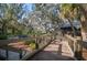Wooden walkway offering scenic views of a tranquil lake and lush landscaping at 13607 Circa Crossing Dr, Lithia, FL 33547