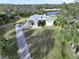 Aerial view of the home, highlighting its driveway and landscaping at 13653 Heritage Way, Sarasota, FL 34240