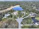 Aerial view of a cul-de-sac neighborhood with several houses and a pond at 13653 Heritage Way, Sarasota, FL 34240