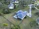 Aerial view showcasing the home's backyard, side yard, and a large grassy area at 13653 Heritage Way, Sarasota, FL 34240