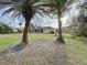 Large backyard with home view and two palm trees at 13653 Heritage Way, Sarasota, FL 34240