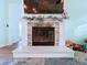 Modern fireplace with stone surround and large mantel at 13653 Heritage Way, Sarasota, FL 34240