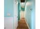 Clean hallway with light blue walls and wood flooring at 13653 Heritage Way, Sarasota, FL 34240