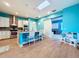 Modern kitchen featuring teal accents, an island, and a barn door at 13653 Heritage Way, Sarasota, FL 34240