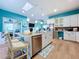 Bright kitchen features island, stainless steel appliances, and white cabinetry at 13653 Heritage Way, Sarasota, FL 34240