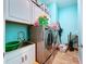Bright laundry room with washer, dryer, and ample cabinet storage at 13653 Heritage Way, Sarasota, FL 34240