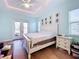 Main bedroom features king size bed, double doors to patio, and plenty of light at 13653 Heritage Way, Sarasota, FL 34240
