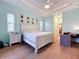 Main bedroom with large bed, wood floors, and private access to backyard at 13653 Heritage Way, Sarasota, FL 34240