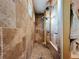 Large walk-in shower with dual shower heads and pebble floor at 13653 Heritage Way, Sarasota, FL 34240