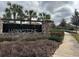 Hawkstone community entrance with stone pillars, landscaping, and a paved walkway at 14215 Swiss Bridge Dr, Riverview, FL 33579