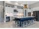 Gourmet kitchen featuring a large island, white cabinets, and breakfast bar at 14215 Swiss Bridge Dr, Riverview, FL 33579