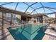 Inviting swimming pool with covered patio and lounge chairs at 14215 Swiss Bridge Dr, Riverview, FL 33579