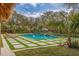 Relaxing pool with tiled patio and tropical plants at 1610 Serpentine S Dr, St Petersburg, FL 33712