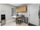 Kitchenette with granite countertops, tiled floors and door leading to the outside of the property at 1712 Blind Pond Ave, Lutz, FL 33549