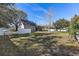 Spacious backyard with large grass area, screened patio, and white fence at 18215 Keystone Grove Blvd, Odessa, FL 33556