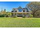 Two-story house with gray siding, a large front yard, and a welcoming entryway at 18215 Keystone Grove Blvd, Odessa, FL 33556