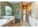 Spa-like bathroom with large shower, soaking tub, and granite vanity at 1840 Douglas Ave, Dunedin, FL 34698