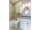 Bathroom with white vanity, granite countertop, and oval mirror at 1840 Douglas Ave, Dunedin, FL 34698