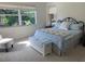 Bright bedroom with large windows, plush bedding, and a cozy sitting area at 1840 Douglas Ave, Dunedin, FL 34698