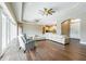 Spacious living room with hardwood floors, sectional sofa, and large windows at 1840 Douglas Ave, Dunedin, FL 34698