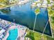 Aerial view of community pool and surrounding patio area next to canal at 18675 Us Highway 19 N # 367, Clearwater, FL 33764