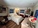 Comfortable bedroom featuring an accent wall, multiple windows and natural light at 1880 Belleair Rd, Clearwater, FL 33764