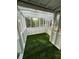 Spacious sunroom with bright, natural light and artificial turf at 1880 Belleair Rd, Clearwater, FL 33764