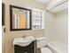 Clean bathroom with white tub, toilet, and dark vanity at 1960 Union St # 42, Clearwater, FL 33763