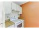 Kitchen features white cabinets, electric stove and wood countertop at 1960 Union St # 42, Clearwater, FL 33763