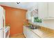 Small kitchen with white cabinets, wood countertop and stainless steel sink at 1960 Union St # 42, Clearwater, FL 33763