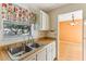 Kitchen features white cabinets, a window, and a view of the dining area at 1960 Union St # 42, Clearwater, FL 33763