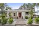 White house with red door, landscaped yard, and brick walkway at 2077 5Th St, Sarasota, FL 34237