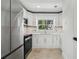 Modern white kitchen featuring stainless steel appliances at 2077 5Th St, Sarasota, FL 34237