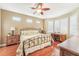 Spacious bedroom with hardwood floors, a ceiling fan, and plantation shutters at 21042 Diamonte Dr, Land O Lakes, FL 34637