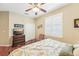 Well-lit bedroom with hardwood floors, a ceiling fan, and plantation shutters at 21042 Diamonte Dr, Land O Lakes, FL 34637