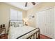 Serene bedroom with hardwood floors, plantation shutters, and a ceiling fan at 21042 Diamonte Dr, Land O Lakes, FL 34637