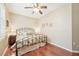 Charming bedroom with hardwood floors, a ceiling fan, and plantation shutters at 21042 Diamonte Dr, Land O Lakes, FL 34637