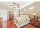 Large bedroom with hardwood floors, king bed, and access to the bathroom at 21042 Diamonte Dr, Land O Lakes, FL 34637