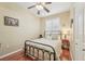 Cozy bedroom with hardwood floors, ceiling fan, and plantation shutters at 21042 Diamonte Dr, Land O Lakes, FL 34637