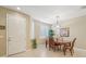 Bright dining room with a wooden table, four chairs, and a window with shutters at 21042 Diamonte Dr, Land O Lakes, FL 34637