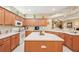 Large kitchen with an island, wood cabinets, and breakfast bar at 21042 Diamonte Dr, Land O Lakes, FL 34637