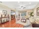 Bright living room with hardwood floors, a large sectional sofa, and a TV at 21042 Diamonte Dr, Land O Lakes, FL 34637