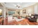 Living room features hardwood floors, a large sofa, and access to a patio at 21042 Diamonte Dr, Land O Lakes, FL 34637