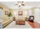 Spacious living room with hardwood floors, light-colored sofa, and ceiling fan at 21042 Diamonte Dr, Land O Lakes, FL 34637