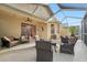 Spacious screened porch with seating and ceiling fan at 21042 Diamonte Dr, Land O Lakes, FL 34637