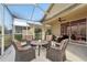 Screened porch with seating for four at 21042 Diamonte Dr, Land O Lakes, FL 34637