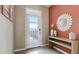 Bright and airy entryway with a modern console table and a large mirror at 226 Royal Spoonbill Dr, Ruskin, FL 33570