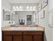 Double vanity bathroom with light wood cabinets at 2307 Dakota Rock Dr, Ruskin, FL 33570