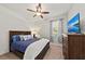 Comfortable bedroom with brick accent wall, ceiling fan and TV at 2307 Dakota Rock Dr, Ruskin, FL 33570