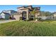 Two-story house with a landscaped lawn and attached garage at 2307 Dakota Rock Dr, Ruskin, FL 33570